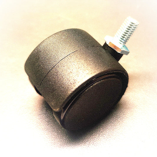 Metal caster wheel with a screw on a beige background